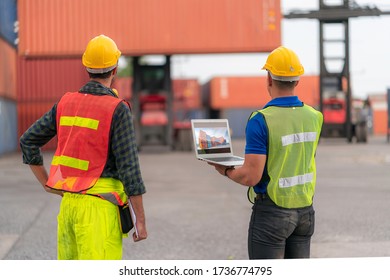 Two Foreman/Engineer Woking Together To Lift The Container In Place Match With Plan