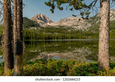 Two forest pine trees make the perfect frame for this mountain sceen in Idaho