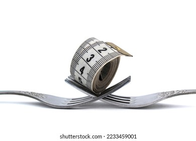 Two forks with a centimeter soft tape lie on a white background. - Shutterstock ID 2233459001