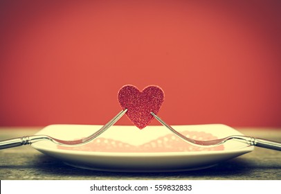Two Forks Holding Red Heart On Wooden Board, Valentines Day Dinner
