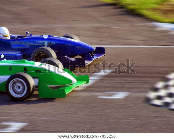 Two formula cars
speeding to finish line