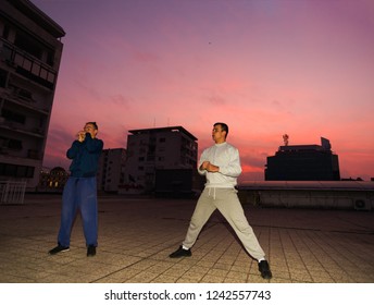 Two free runner on the balcony doing parkour workout on the sunrise - Powered by Shutterstock