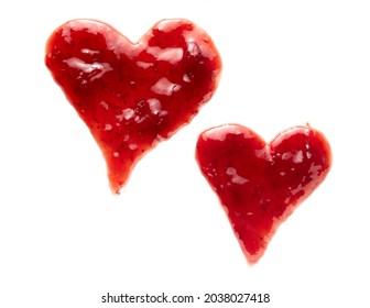 Two freehand hearts drawn of red berry jam on white with different sizes and shapes conceptual of love, like and romance
