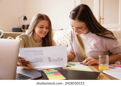 Two freelancer Friends Analyzing Data and Discussing Work at Home, studying charts