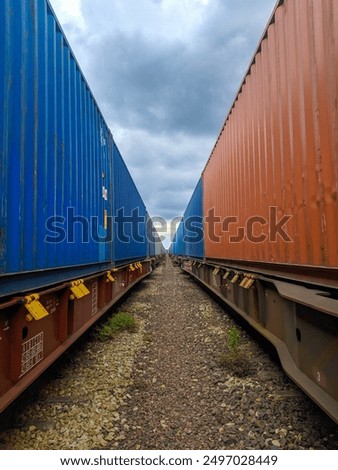 Two Freight Trains with Containers Standing Side by Side