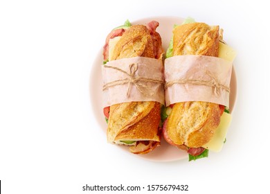 Two Fresh Big Baguette Sandwich With Bacon, Chedder Cheese, Mustard, Lettuce And Vegetables Isolated On Plate On White Background