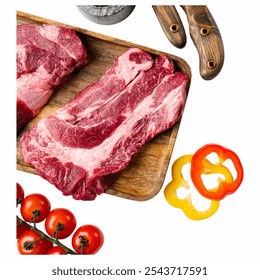 Two fresh cuts of beef are displayed on a wooden platter, accompanied by vibrant yellow and red bell peppers and ripe cherry tomatoes, highlighting culinary freshness. - Powered by Shutterstock