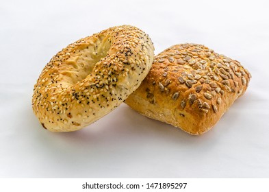 Two Fresh Delicious Bred Rolls Straight From The Oven With Sesame Seeds On A White Background.