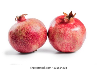 Two fresh pomegranates isolated on a white background - Shutterstock ID 531564298