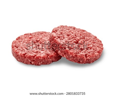 Two fresh, raw minced beef burger patties perfectly shaped and ready for grilling, isolated on a solid white background with soft shadows