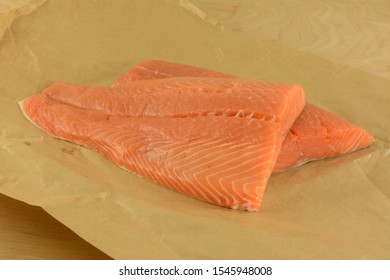 Two Fresh Raw Salmon Fish Fillets On Brown On Opened Brown Butcher Paper