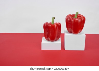 Two Fresh Red Chiles Ready To Cook On A Red And White Background, No People