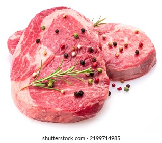 Two fresh ribeye steaks with peppercorn and rosemary isolated on white background. Closeup. 