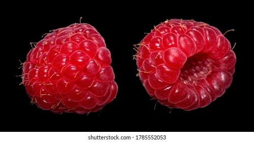 Two fresh ripe raspberry isolated on a black background. Macro shot.