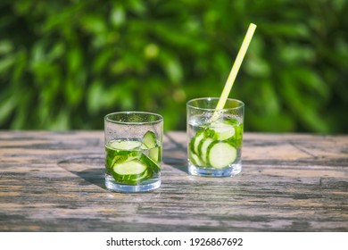 Two Freshly Prepared Summer Cocktails In A Glass. Cold Drinking Cucumber Water On A Hot Sunny Day In Nature