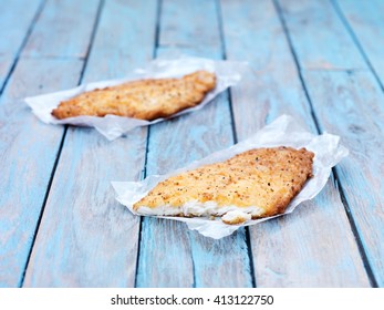 Two Fried Breaded Flounder Fish Pieces On Wooden Table