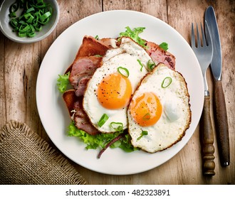 Two Fried Eggs On White Plate