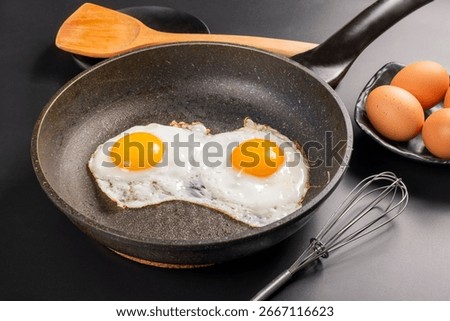 Two fried eggs in a pan