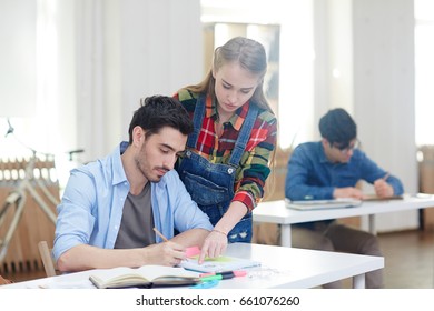 Two friendly students discussing task in notebook - Shutterstock ID 661076260