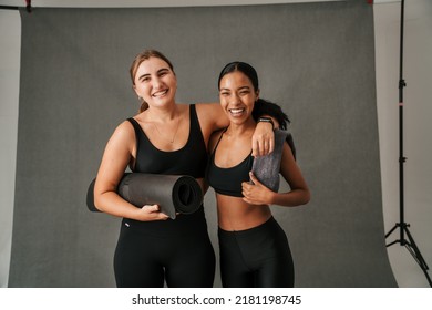 Two Friends Arm In Arm Getting Ready For Yoga Work Out 