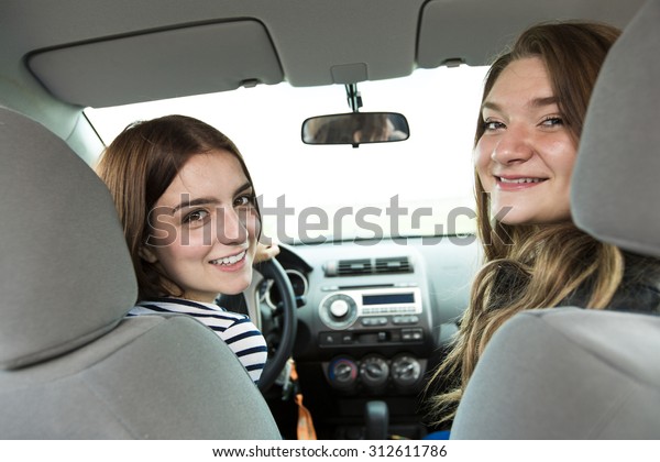 two\
friends in car who is happy to have is new\
car