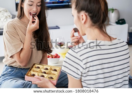 Similar – Image, Stock Photo Two friends enjoying a warm embrace in a sunny park