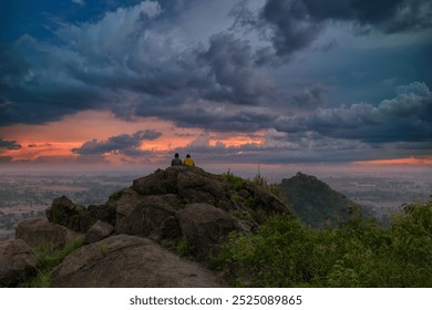 Two friends enjoying the cloudy  late evening  view from a hilltop   - Powered by Shutterstock