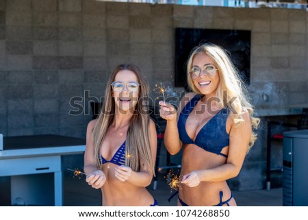 Two friends enjoying each others company in an outdoor environment with sparklers