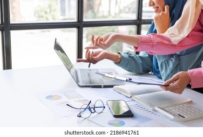 Two Friends Female Charming Asian Muslim Lady Wearing Hijab Working And Discussing At Meeting In Office.