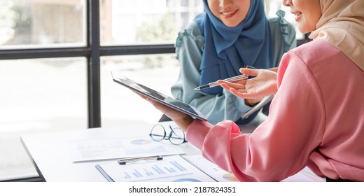 Two Friends Female Charming Asian Muslim Lady Wearing Hijab Working And Discussing At Meeting In Office.