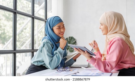 Two Friends Female Charming Asian Muslim Lady Wearing Hijab Working And Discussing At Meeting In Office.