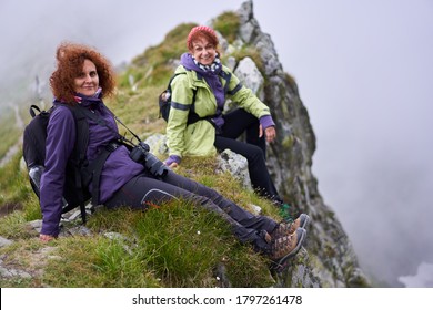 Two Friends Female Tourists With Backpacks Together Hiking In The Mountains