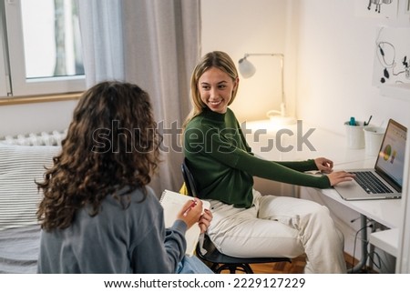 Two friends having a discussion while studying