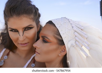 Two Friends Having A Moment In Burning Man Desert Warrior Outfits