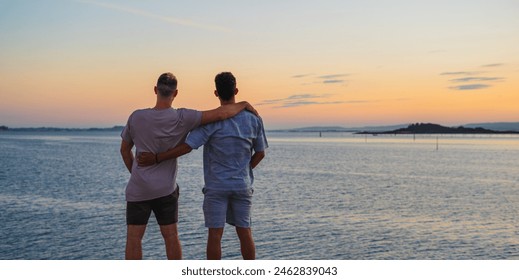 two friends hugging looking at the sea horizon while pissing together on the sunset - Powered by Shutterstock