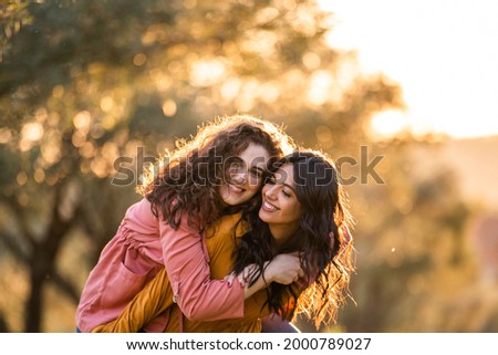 two friends, a lesbian couple in the park at sunset. lesbian concept