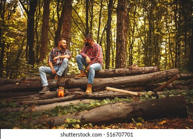 Two friends Lumberjack worker sitting in the forest .Resting after hard work. - Powered by Shutterstock