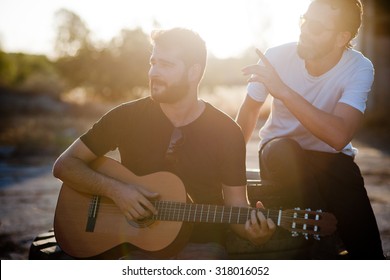 Two Friends Playing Guitar