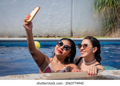 Two Friends In A Pool Taking A Selfie