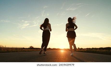 two friends running sunset, team group girls running sunset, silhouette athletic girls, teamwork enjoying life, young active sport athlete, sports track morning, runner man, treadmill sunset, people