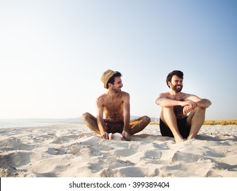 Two friends seating on the beach together