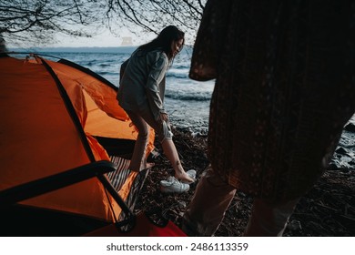 Two friends setting up a tent at a lakeside campsite, enjoying nature and relaxation on a leisure weekend getaway. - Powered by Shutterstock