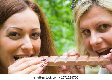 Two Friends Sharing Large Chocolate Bar, Portrait