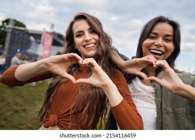 Two Friends Showing  Heard Shape At Music Festival 