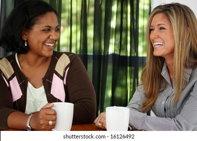 Two Friends Sitting At A Table Together