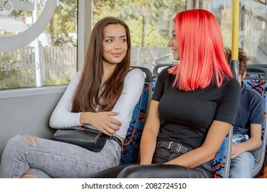 Two friends take the public transport bus to the city, they talk all the way, summer afternoon, beautiful women of diverse beauty sit on chairs, heading to the university, school, spontaneous meeting