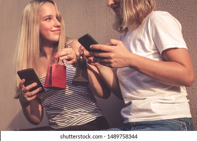 Two Friends Of Teenagers A Generation Z Shop Online With A Credit Card And Smartphone On A Street Black Friday Discounts Sale