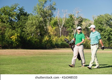 Two Friends Walking Down The Golf Course