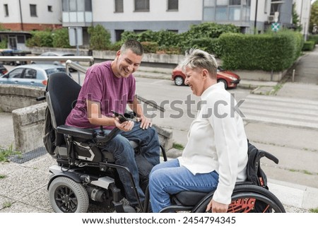 Similar – Image, Stock Photo Joyful wheelchair user with assistant enjoying outdoors