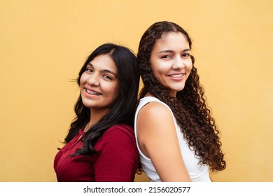 Two Friends Women With Brackets Together Looking At Camera.